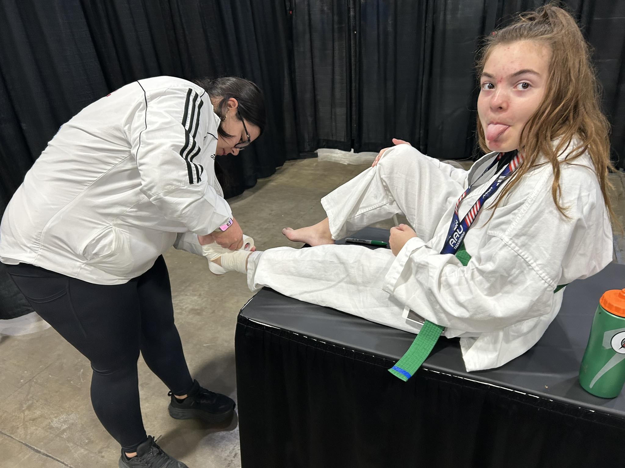 Amelia Werner receiving ankle support during competition
