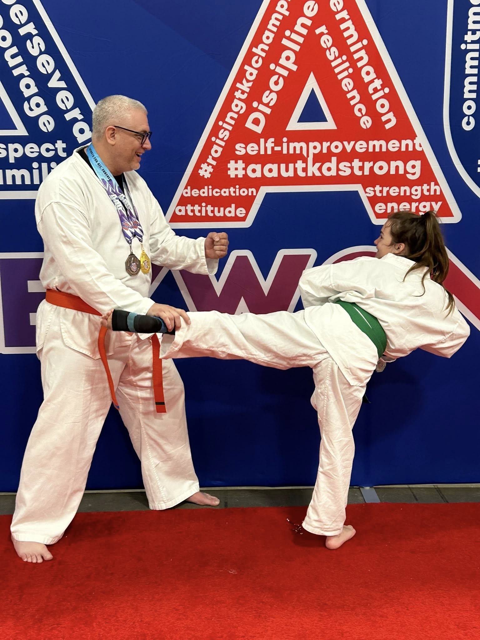 Master Thomas Werner coaching Amelia Werner on a kick